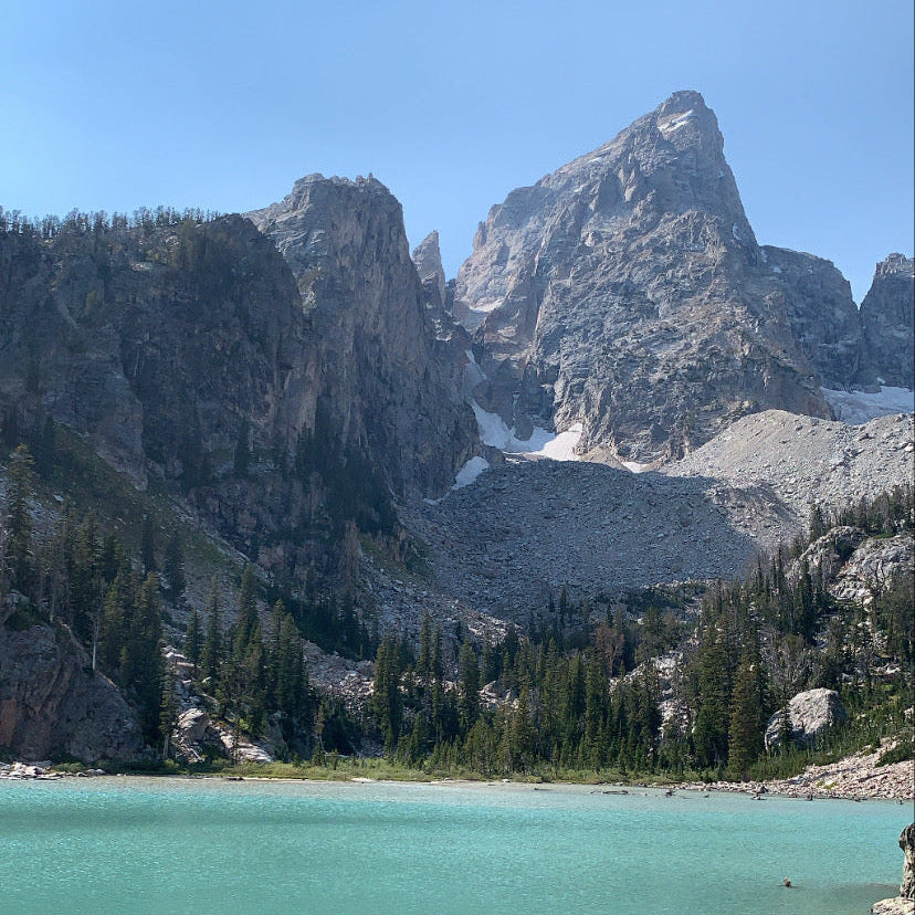 <p>Our Founder, Ben, draws a simple logo in the dirt in the heart of Jackson Hole, after summiting Mount Superior for the first time the week before. </p>